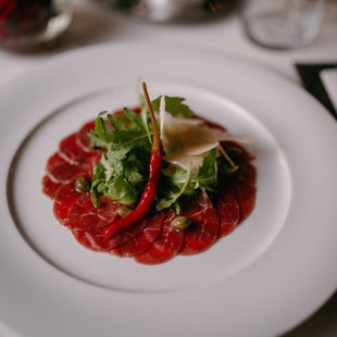 BEEF CARPACCIO WITH WHITE WINE AND CHILI SAUCE, PARMIGIANO SHAVINGS